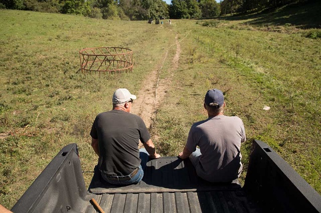 Two men on a truck tailgate.