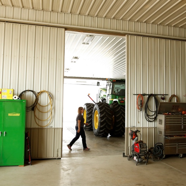 Machine shop with large green tractor.